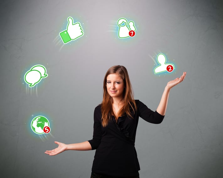 attractive young woman standing and juggling with social network icons